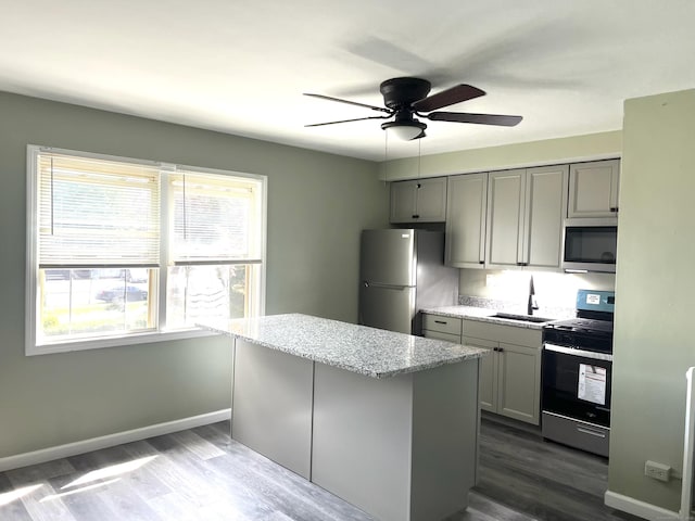 401 Granfield Ave Unit C Bldg 2, Bridgeport, CT 06610 - kitchen featuring range with gas cooktop, stainless steel microwave, gray cabinets, freestanding refrigerator, and dark wood-style flooring