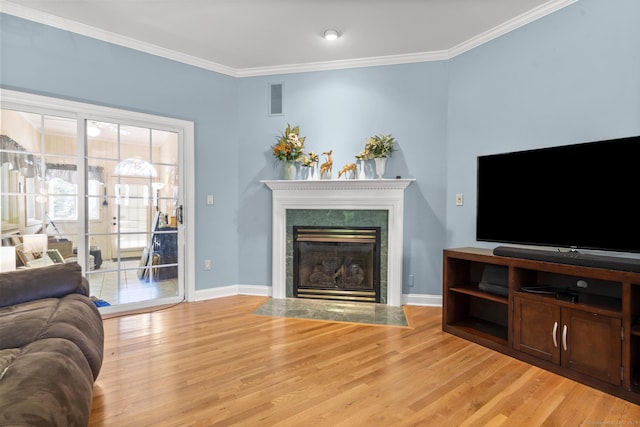 50 Middlebrooks Ave, Trumbull, CT 06611 - living area with light wood-type flooring, crown molding, and a fireplace with flush hearth