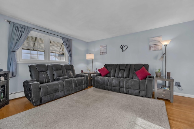 34 Fleming Ct, Groton, CT 06340 - living area featuring a baseboard heating unit and wood finished floors
