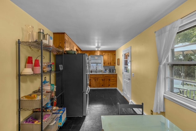 34 Fleming Ct, Groton, CT 06340 - kitchen featuring freestanding refrigerator, brown cabinets, and light countertops