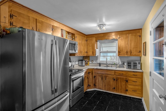 34 Fleming Ct, Groton, CT 06340 - kitchen with stainless steel appliances, brown cabinetry, backsplash, and light countertops