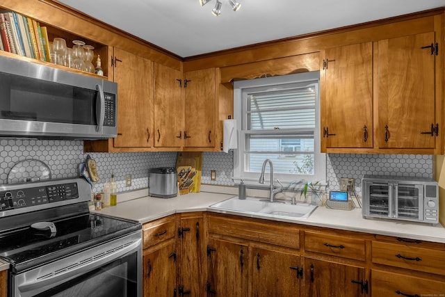 34 Fleming Ct, Groton, CT 06340 - kitchen with appliances with stainless steel finishes, backsplash, light countertops, and brown cabinetry