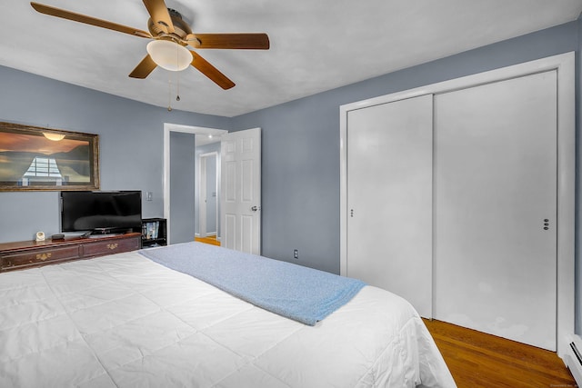 34 Fleming Ct, Groton, CT 06340 - bedroom with wood finished floors, a baseboard radiator, a closet, and ceiling fan