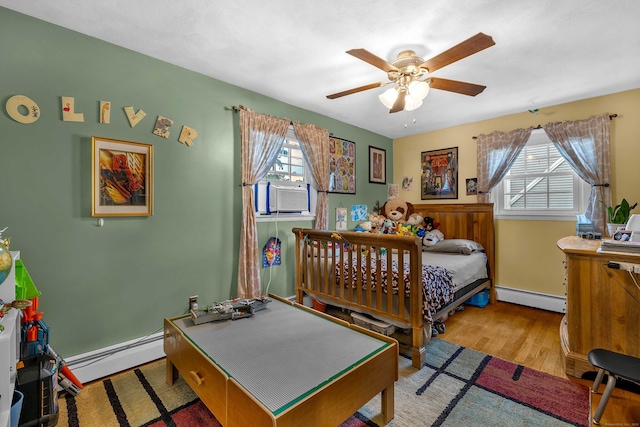34 Fleming Ct, Groton, CT 06340 - bedroom featuring a baseboard heating unit, cooling unit, wood finished floors, and a ceiling fan