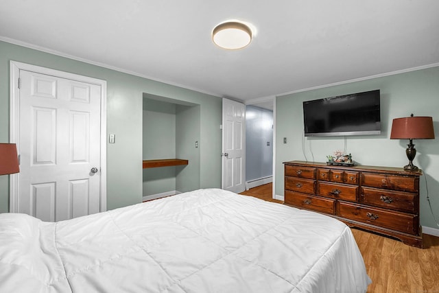 34 Fleming Ct, Groton, CT 06340 - bedroom with baseboard heating, wood finished floors, and crown molding