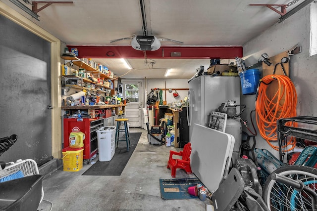 34 Fleming Ct, Groton, CT 06340 - garage with a garage door opener and a workshop area