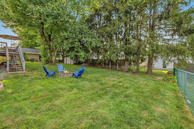 34 Fleming Ct, Groton, CT 06340 - fenced yard with stairway, an outdoor fire pit, a shed, and a wooden deck