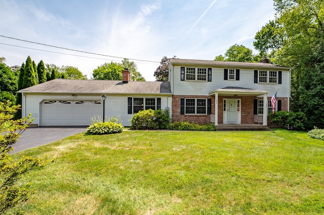 198 N Timber Ln, Cheshire, CT 06410 - view of front of property featuring a chimney, a garage, brick siding, driveway, and a front yard