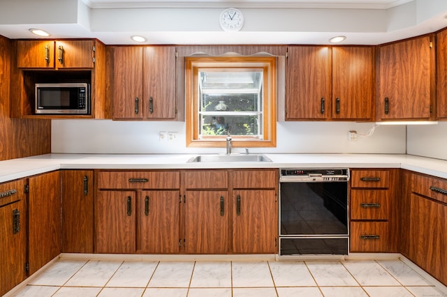 198 N Timber Ln, Cheshire, CT 06410 - kitchen with black dishwasher, stainless steel microwave, light marble finish floors, light countertops, and brown cabinets