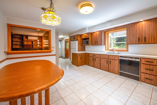 198 N Timber Ln, Cheshire, CT 06410 - kitchen with black dishwasher, stainless steel microwave, freestanding refrigerator, light countertops, and brown cabinets