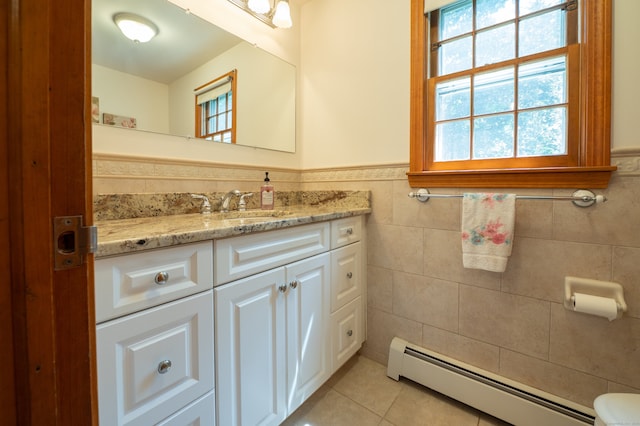 198 N Timber Ln, Cheshire, CT 06410 - half bath with baseboard heating, healthy amount of natural light, tile walls, vanity, and a wainscoted wall