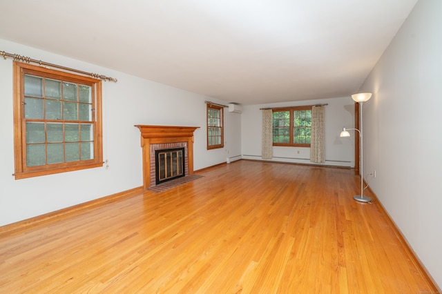 198 N Timber Ln, Cheshire, CT 06410 - unfurnished living room featuring baseboard heating, wood finished floors, and a brick fireplace