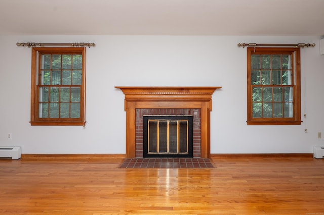 198 N Timber Ln, Cheshire, CT 06410 - detailed view of wood finished floors, baseboard heating, a brick fireplace, and a baseboard heating unit