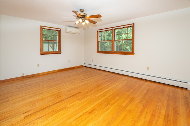 198 N Timber Ln, Cheshire, CT 06410 - spare room featuring baseboard heating, a wall mounted air conditioner, healthy amount of natural light, and light wood-type flooring