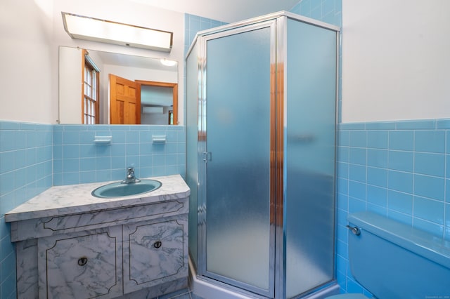 198 N Timber Ln, Cheshire, CT 06410 - bathroom featuring tile walls, vanity, a stall shower, and a wainscoted wall