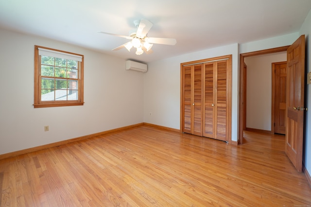198 N Timber Ln, Cheshire, CT 06410 - unfurnished bedroom featuring a wall mounted air conditioner, light wood-style floors, a closet, and a ceiling fan