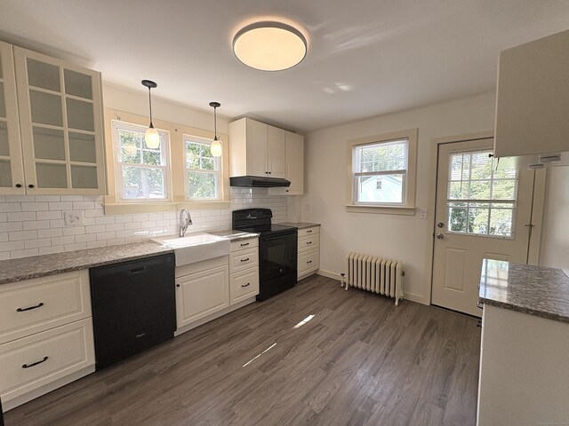 3 Mountain View Ave, Enfield, CT 06082 - kitchen featuring black appliances, radiator, under cabinet range hood, dark wood-style flooring, and decorative backsplash