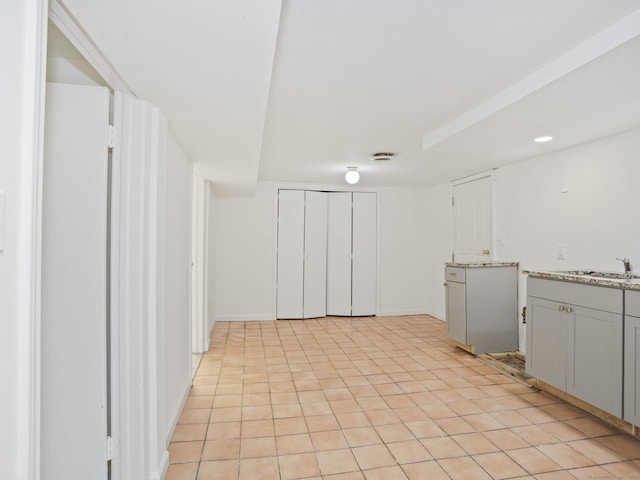 62 Severance Dr, Stamford, CT 06905 - kitchen featuring light stone countertops and gray cabinetry