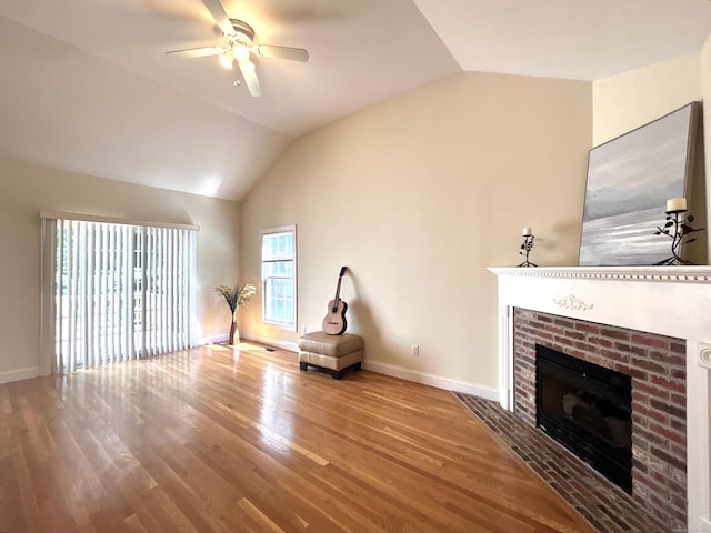 41 Calloway Dr, Milford, CT 06461 - unfurnished living room with lofted ceiling, a fireplace, wood finished floors, and a ceiling fan