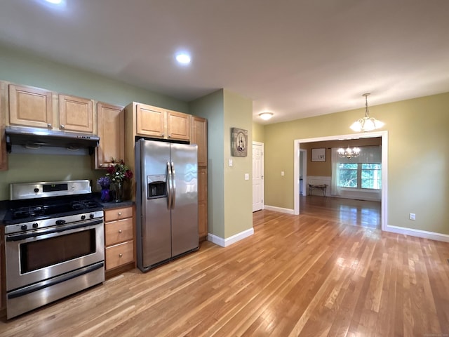 41 Calloway Dr, Milford, CT 06461 - kitchen featuring appliances with stainless steel finishes, under cabinet range hood, light brown cabinetry, a chandelier, and light wood-style floors