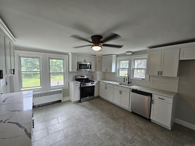 24 Lake Ave, Danbury, CT 06810 - kitchen featuring radiator, stainless steel appliances, white cabinets, and ceiling fan