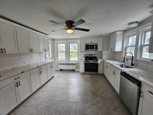 24 Lake Ave, Danbury, CT 06810 - kitchen featuring appliances with stainless steel finishes, radiator heating unit, healthy amount of natural light, and tasteful backsplash