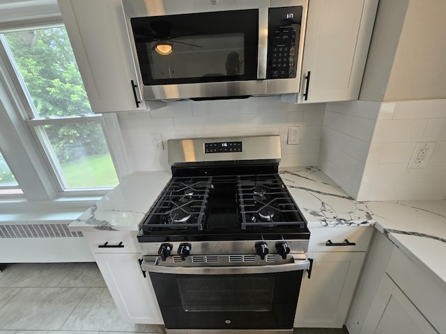 24 Lake Ave, Danbury, CT 06810 - kitchen view of stainless steel appliances, light stone countertops, backsplash, and white cabinetry