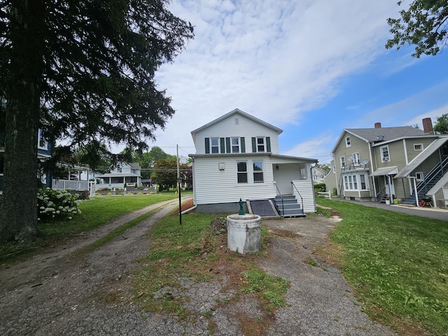 24 Lake Ave, Danbury, CT 06810 - back of property with a lawn, dirt driveway, and a residential view