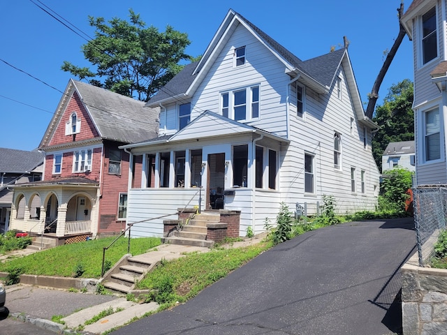 21 Arch St, Waterbury, CT 06710 - view of front of home with covered porch and a shingled roof