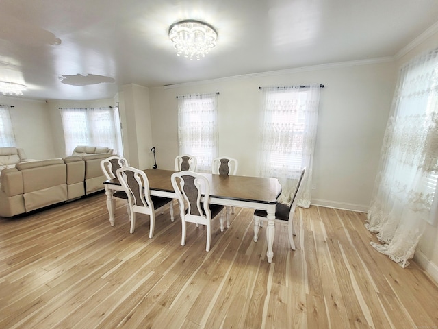 21 Arch St, Waterbury, CT 06710 - dining space with ornamental molding, light wood-style flooring, and a chandelier
