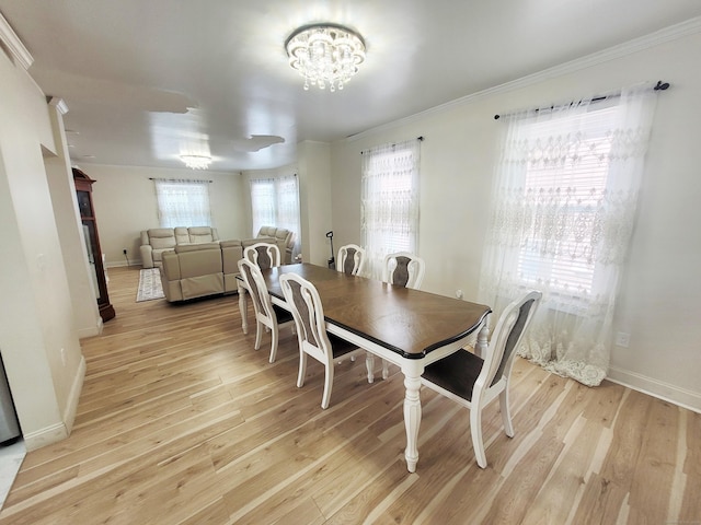 21 Arch St, Waterbury, CT 06710 - dining area with ornamental molding, light wood finished floors, and a chandelier