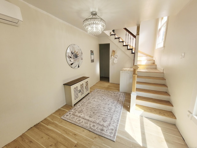 21 Arch St, Waterbury, CT 06710 - entryway featuring a wall mounted AC, a chandelier, stairway, wood finished floors, and ornamental molding