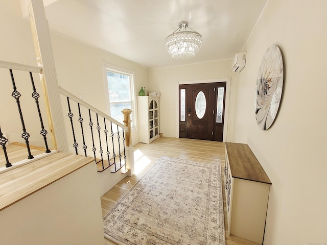 21 Arch St, Waterbury, CT 06710 - foyer featuring a chandelier, a wall unit AC, wood finished floors, and stairway