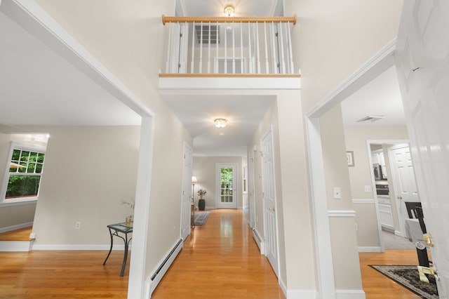 15 Tisbury Rd, Old Lyme, CT 06371 - corridor with a baseboard heating unit and light wood-style floors