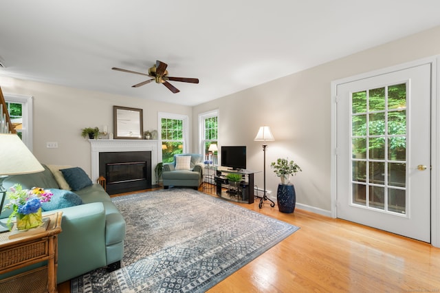 15 Tisbury Rd, Old Lyme, CT 06371 - living room with wood finished floors, ceiling fan, and a fireplace with flush hearth