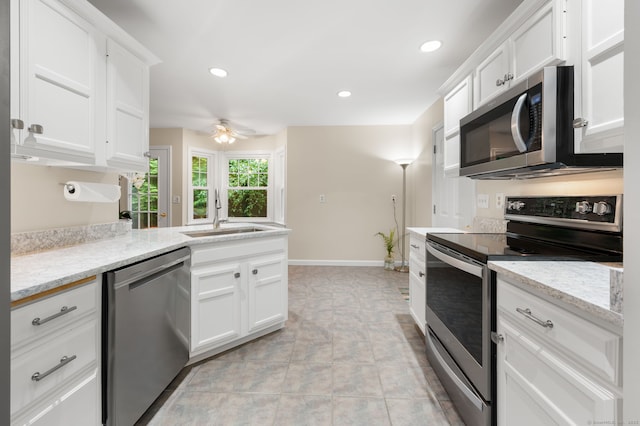 15 Tisbury Rd, Old Lyme, CT 06371 - kitchen with stainless steel appliances, ceiling fan, white cabinets, recessed lighting, and a peninsula