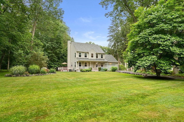 15 Tisbury Rd, Old Lyme, CT 06371 - view of front facade featuring a front yard, an attached garage, and a chimney