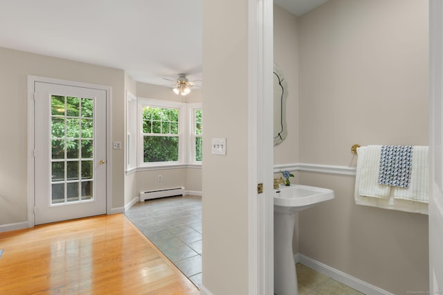15 Tisbury Rd, Old Lyme, CT 06371 - bathroom featuring baseboard heating, a ceiling fan, and wood finished floors