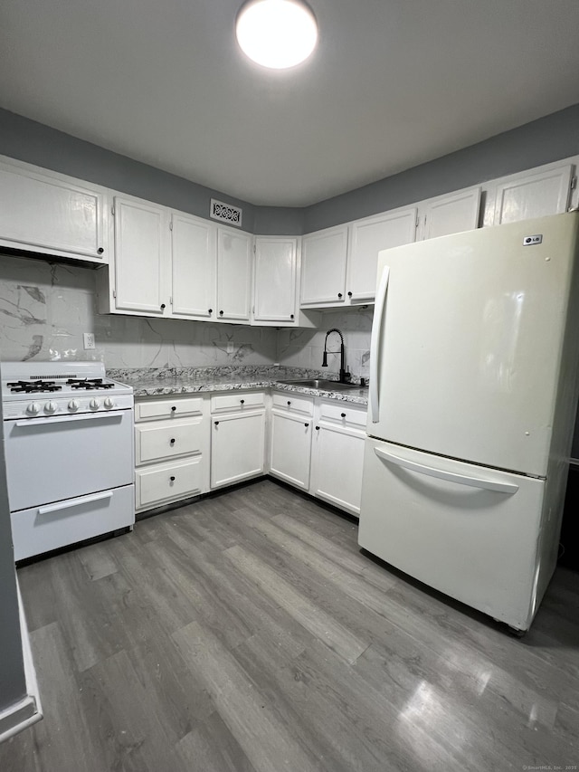6 Victory Dr, New Haven, CT 06515 - kitchen with white appliances, white cabinets, dark wood-style flooring, tasteful backsplash, and light stone countertops