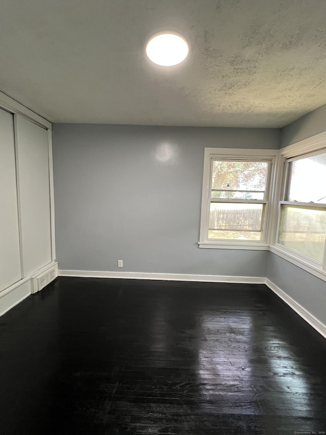 6 Victory Dr, New Haven, CT 06515 - empty room featuring dark wood finished floors and a textured ceiling