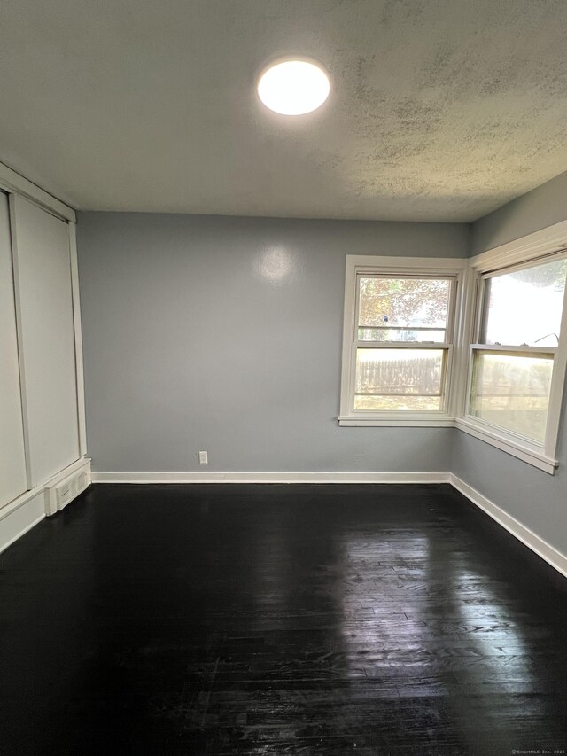 6 Victory Dr, New Haven, CT 06515 - spare room with dark wood-style flooring and a textured ceiling