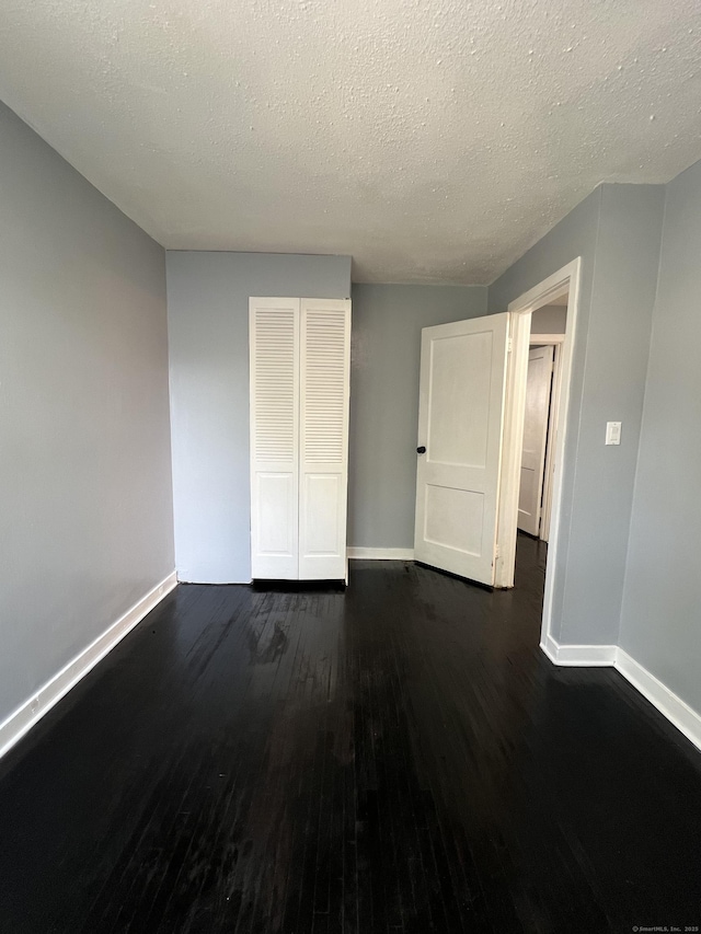 6 Victory Dr, New Haven, CT 06515 - unfurnished bedroom featuring dark wood finished floors, a closet, and a textured ceiling