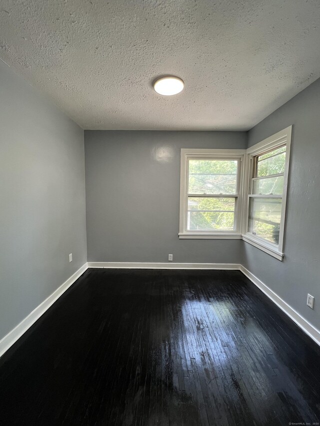 6 Victory Dr, New Haven, CT 06515 - spare room with dark wood-style flooring and a textured ceiling