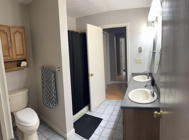 4 Starrwood Dr Unit 4, Norwich, CT 06360 - full bathroom with tile patterned flooring, double vanity, a shower with curtain, and a textured ceiling