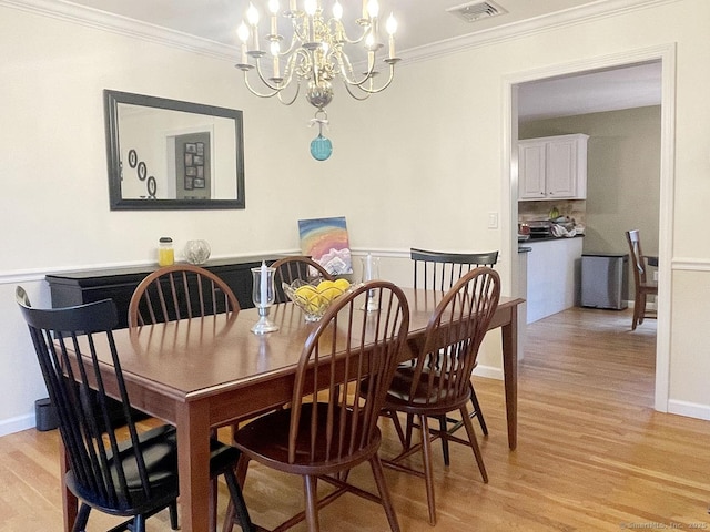 1040 Purchase Brook Rd, Southbury, CT 06488 - dining space featuring light wood-type flooring, a chandelier, and crown molding