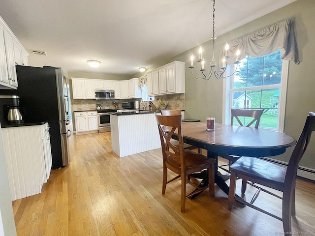 1040 Purchase Brook Rd, Southbury, CT 06488 - dining space with a chandelier and light wood finished floors