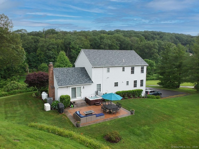 1040 Purchase Brook Rd, Southbury, CT 06488 - back of property with a patio area, a yard, a wooded view, and a chimney