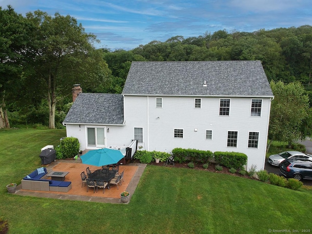 1040 Purchase Brook Rd, Southbury, CT 06488 - rear view of property with a chimney, a yard, roof with shingles, outdoor dining space, and a view of trees