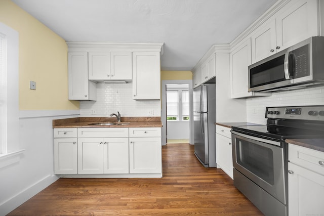 47 Park Ave, Enfield, CT 06002 - kitchen with stainless steel appliances, dark countertops, decorative backsplash, and white cabinetry