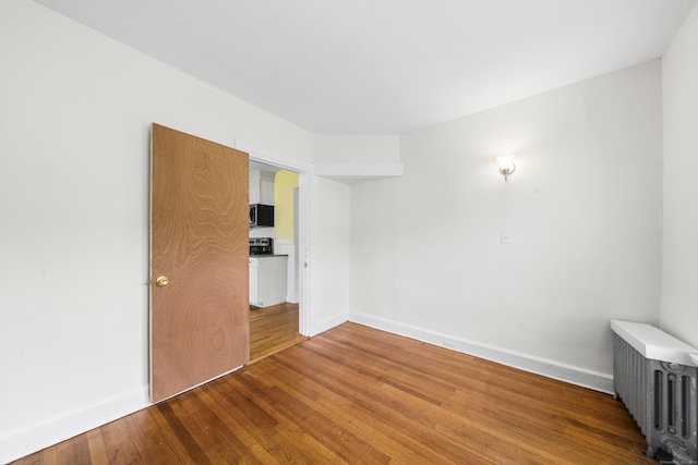 47 Park Ave, Enfield, CT 06002 - empty room with radiator and wood finished floors